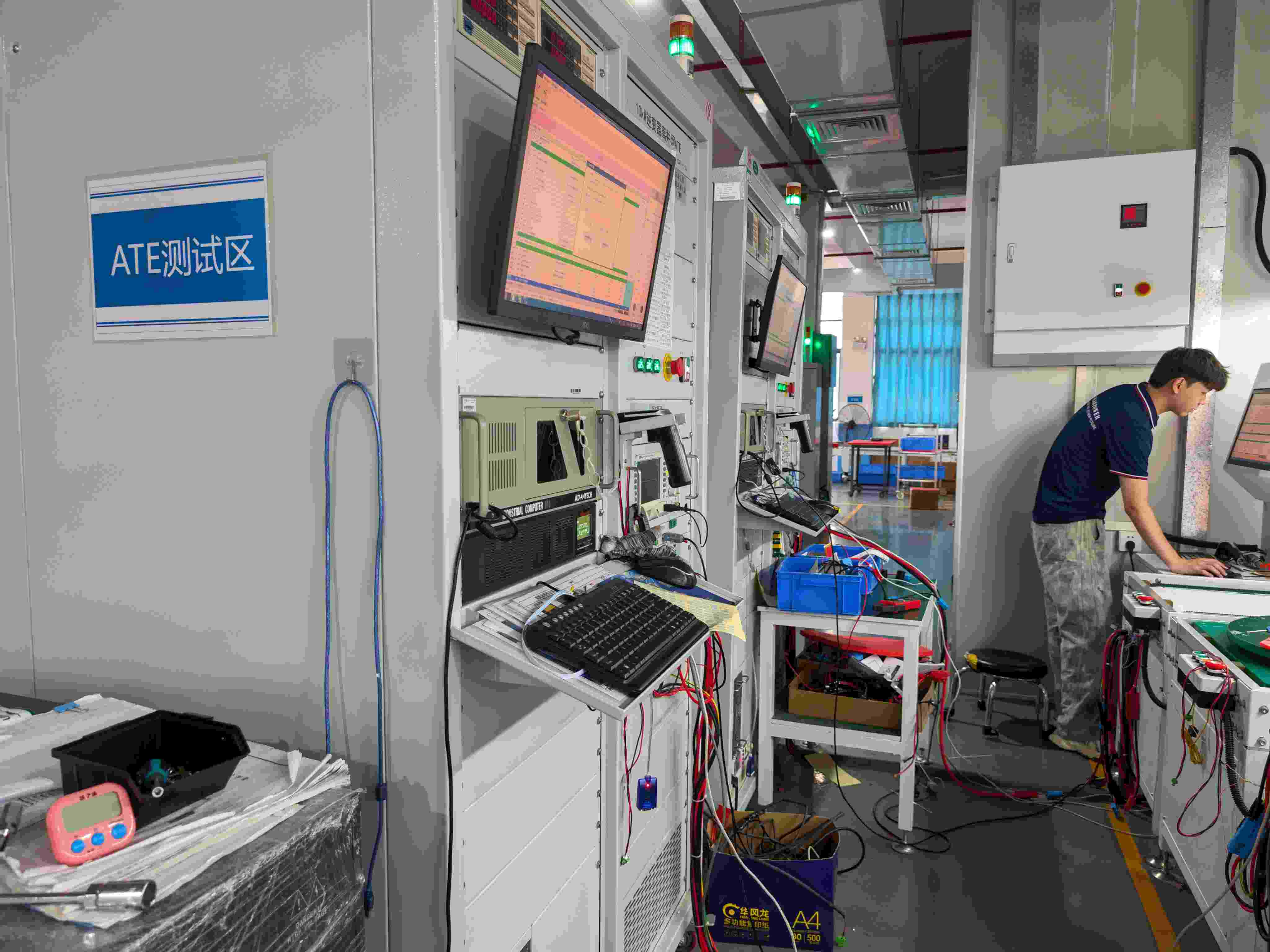 Solar Inverter ATE Automated Testing Technician performing automated electrical and functional testing on solar inverters in the SNAT Solar factory.