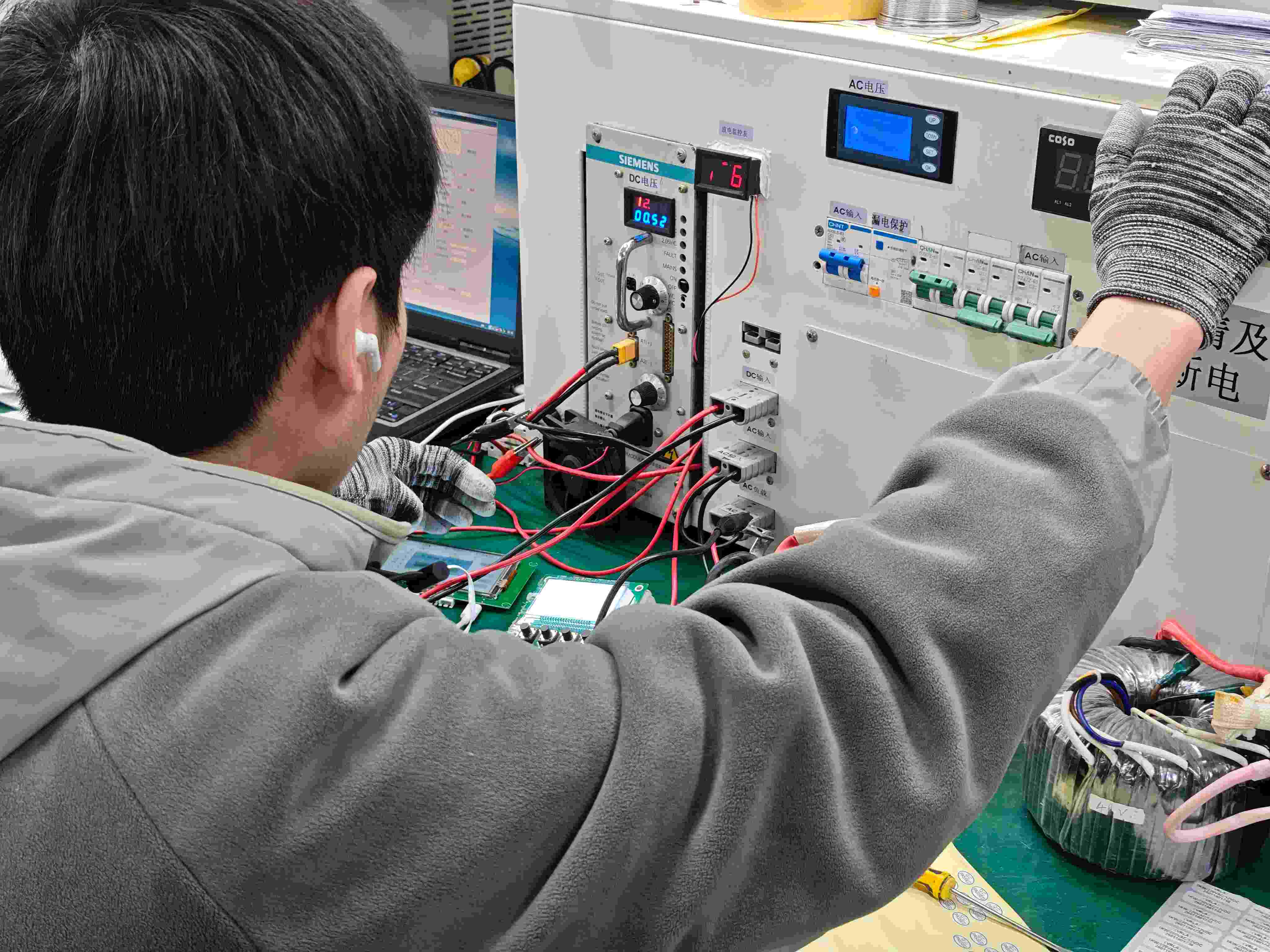 Solar Inverter PCB Assembly and Quality Control Workers assembling and inspecting solar inverter PCB boards on the SNAT Solar production line.