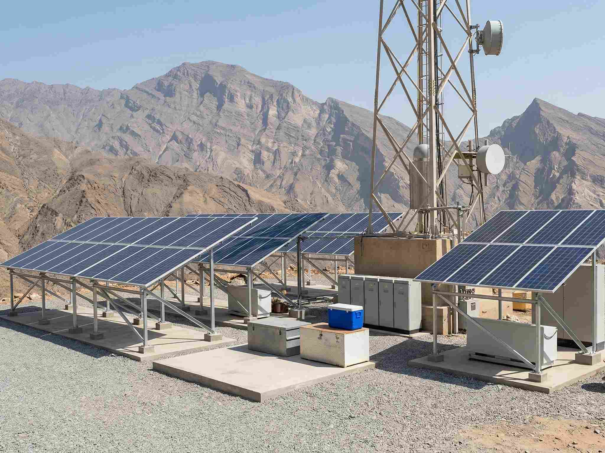 An off-grid solar energy solution featuring multiple solar panel arrays in a mountainous landscape.
