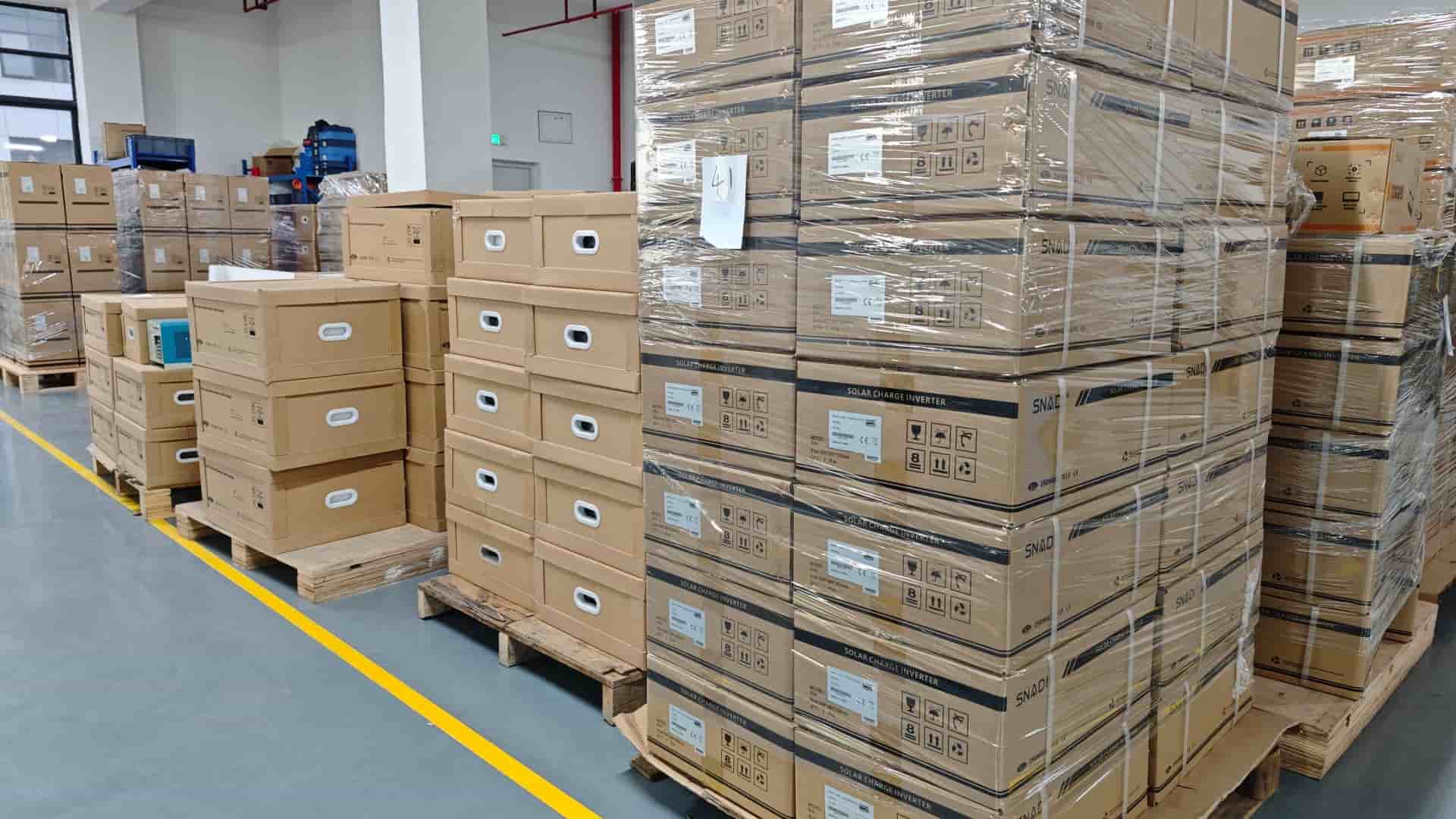 Large quantities of SNADI branded solar charge inverters and energy products packed in cardboard box
