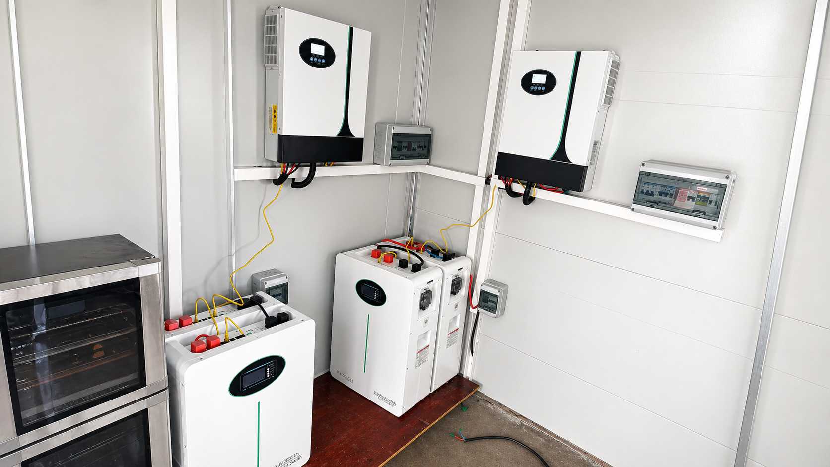 Modern indoor home energy storage system (ESS) featuring wall-mounted hybrid inverters and lithium b